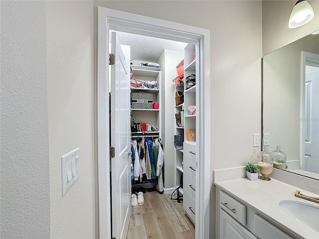 bathroom featuring vanity, hardwood / wood-style floors, and a textured ceiling