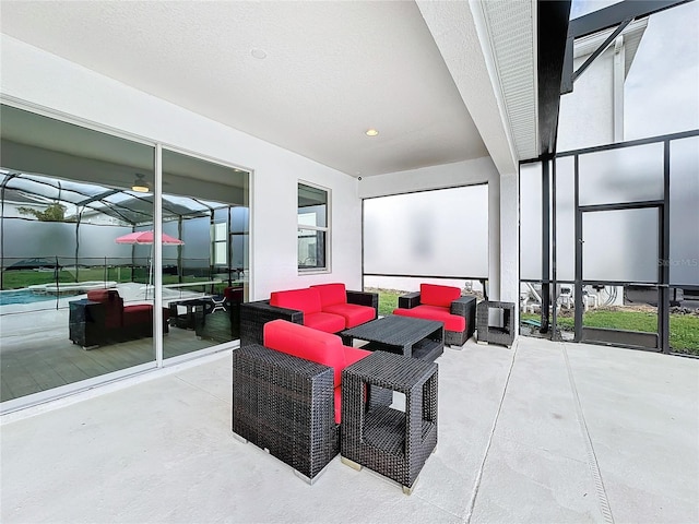 view of patio with an outdoor living space and glass enclosure