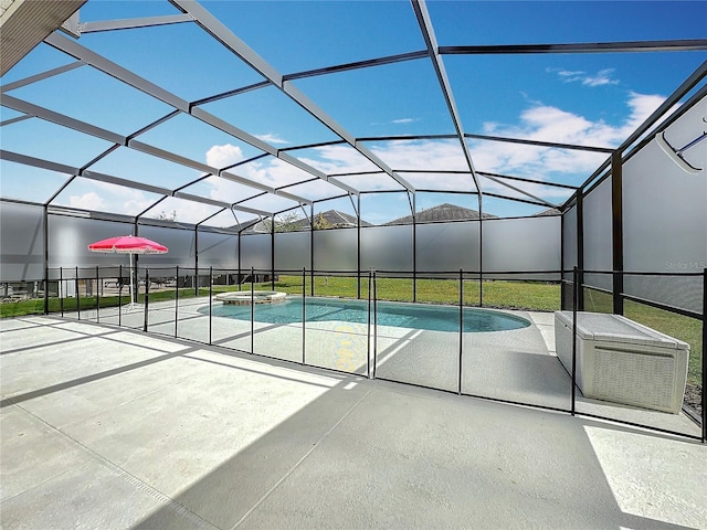 view of swimming pool with glass enclosure and a patio area