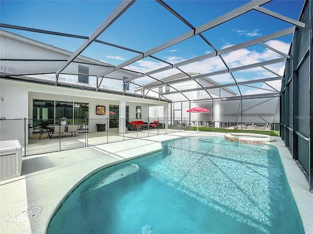 view of swimming pool featuring an in ground hot tub, a lanai, and a patio area