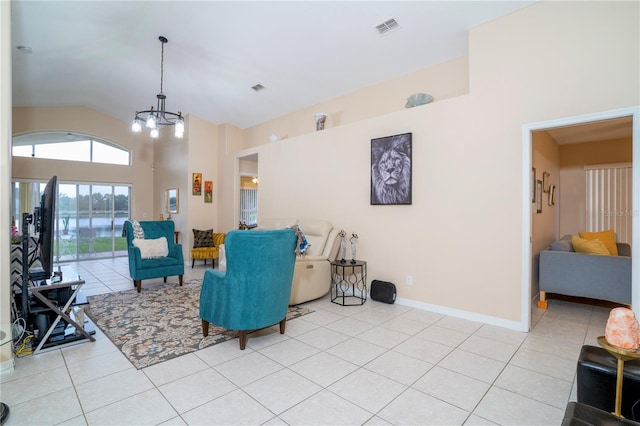 living room with light tile patterned floors, lofted ceiling, and a notable chandelier