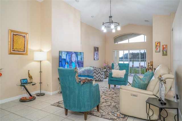 living room featuring a chandelier, lofted ceiling, and light tile patterned flooring