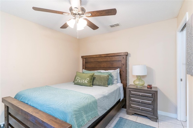 bedroom with light tile patterned floors, a textured ceiling, and ceiling fan