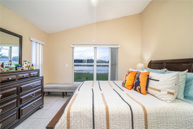 tiled bedroom featuring a water view and lofted ceiling