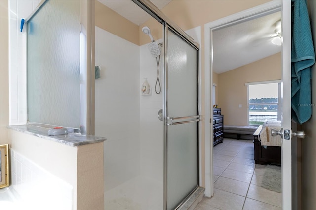 bathroom with tile patterned floors, an enclosed shower, and lofted ceiling