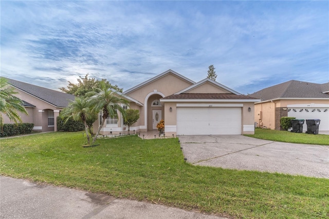 ranch-style home featuring a garage and a front lawn