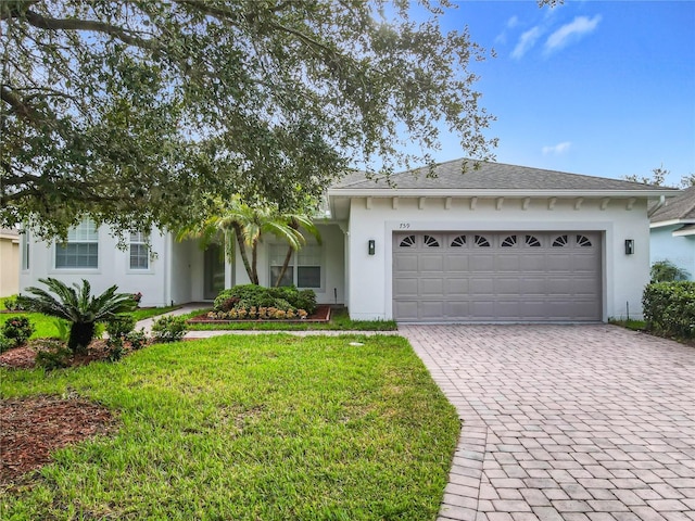 view of front facade with a garage and a front lawn