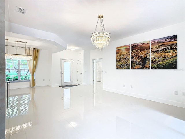 tiled empty room featuring a notable chandelier