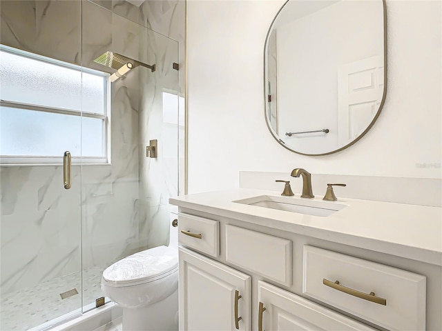 bathroom featuring vanity, toilet, and an enclosed shower