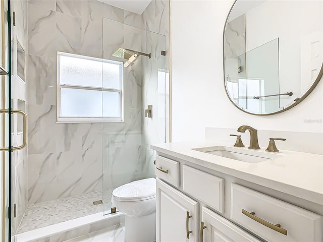 bathroom featuring vanity, toilet, and an enclosed shower