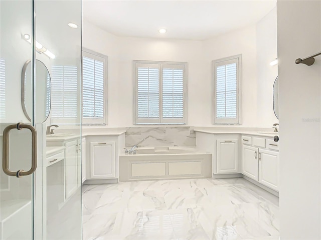 bathroom featuring a washtub and vanity