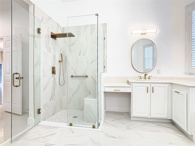 bathroom with a shower with door, vanity, and plenty of natural light