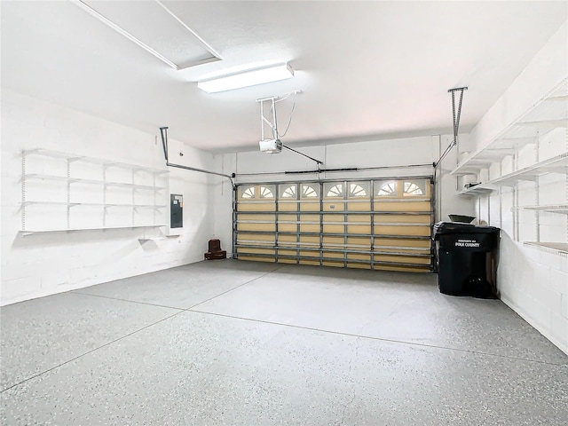 garage with electric panel and a garage door opener