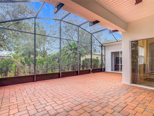 view of patio featuring glass enclosure