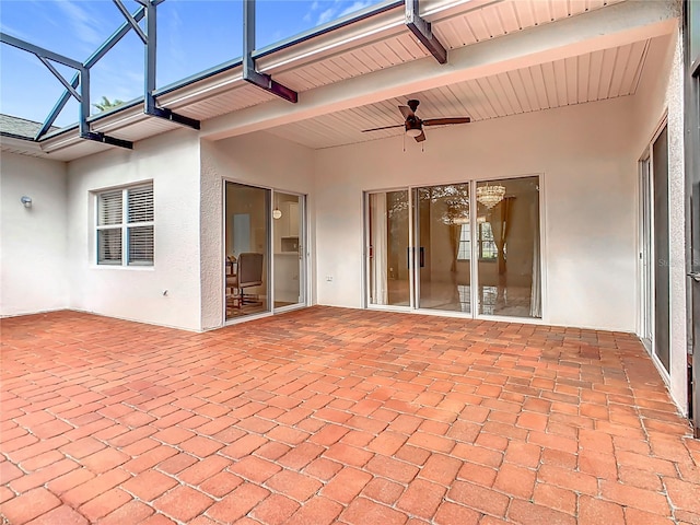 unfurnished sunroom featuring ceiling fan and beam ceiling