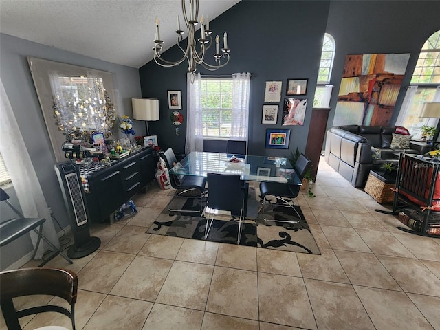 tiled dining space featuring high vaulted ceiling, a chandelier, and a textured ceiling