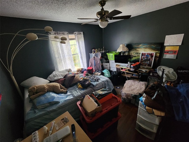 bedroom with dark wood-type flooring, a textured ceiling, and ceiling fan