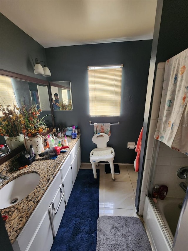 bathroom with vanity, tile patterned floors, and combined bath / shower with glass door