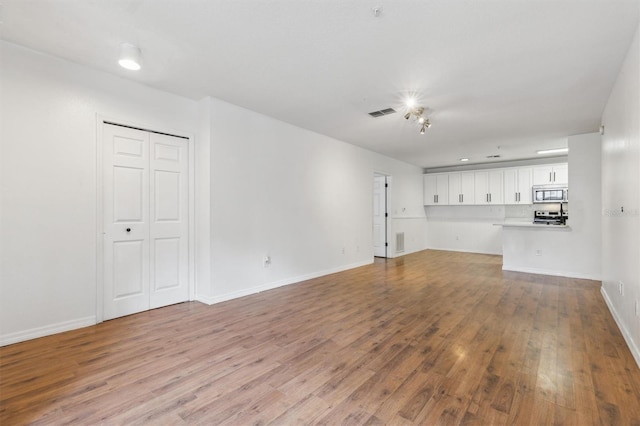 unfurnished living room featuring hardwood / wood-style floors