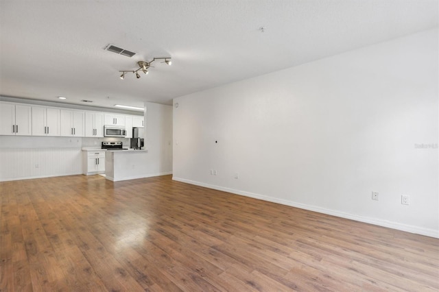 unfurnished living room with light hardwood / wood-style floors