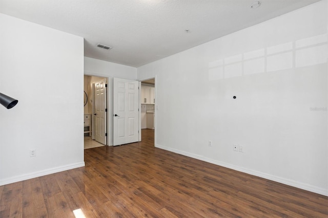 spare room with dark hardwood / wood-style flooring