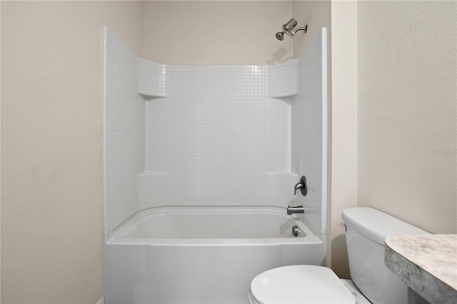 bathroom featuring toilet and tiled shower / bath