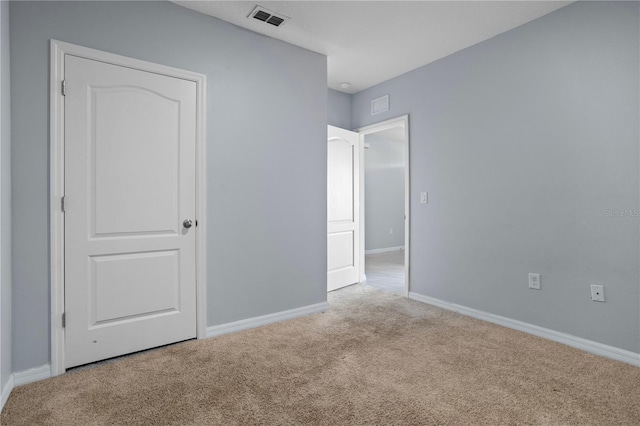 unfurnished bedroom featuring light carpet