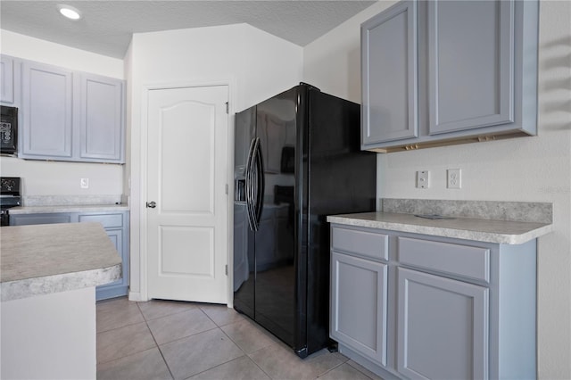 kitchen featuring black appliances, gray cabinets, and a textured ceiling