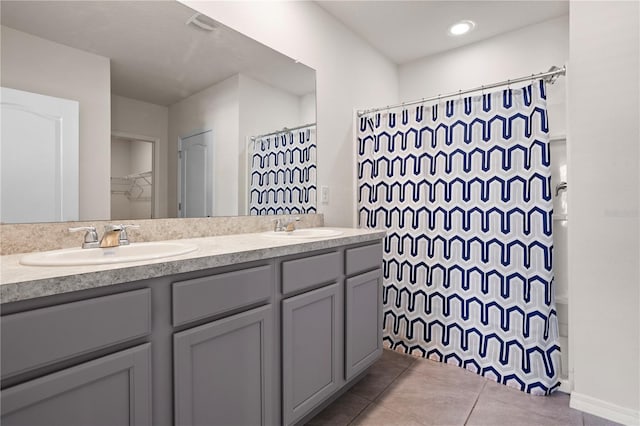 bathroom featuring curtained shower, tile patterned flooring, and vanity