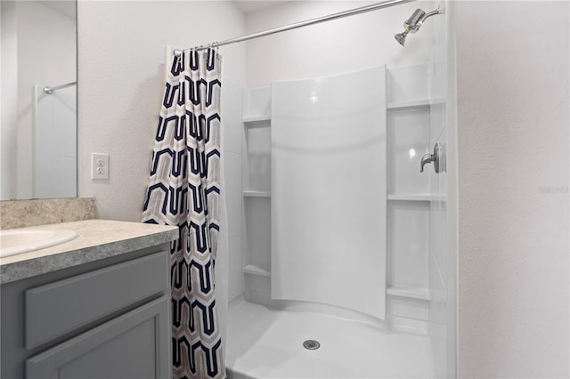 bathroom featuring a shower with shower curtain and vanity