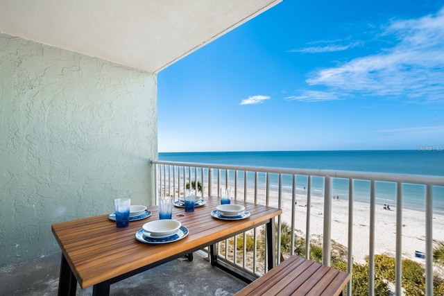 balcony with a beach view and a water view