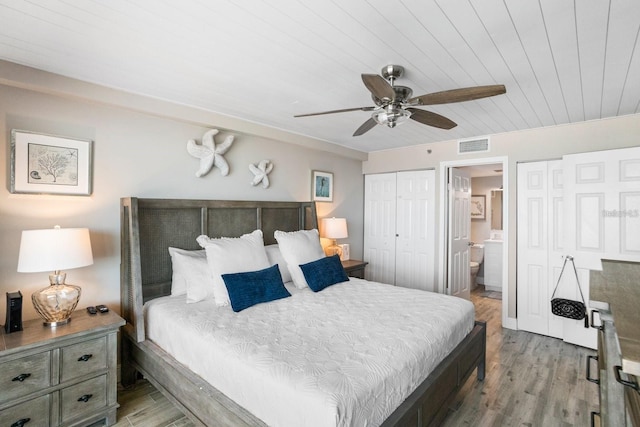 bedroom featuring wooden ceiling, light hardwood / wood-style floors, ceiling fan, and ensuite bath