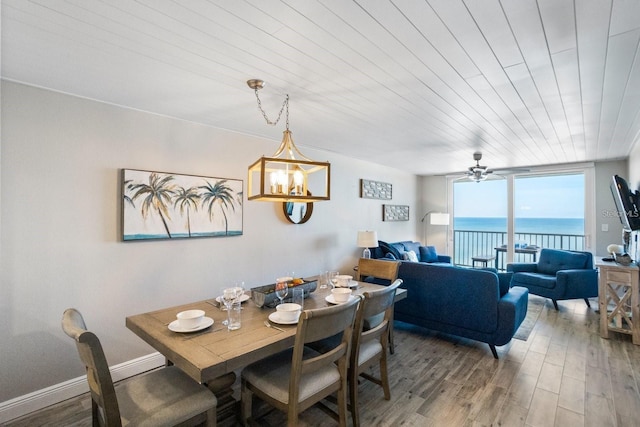 dining space featuring wood-type flooring, wood ceiling, and ceiling fan with notable chandelier