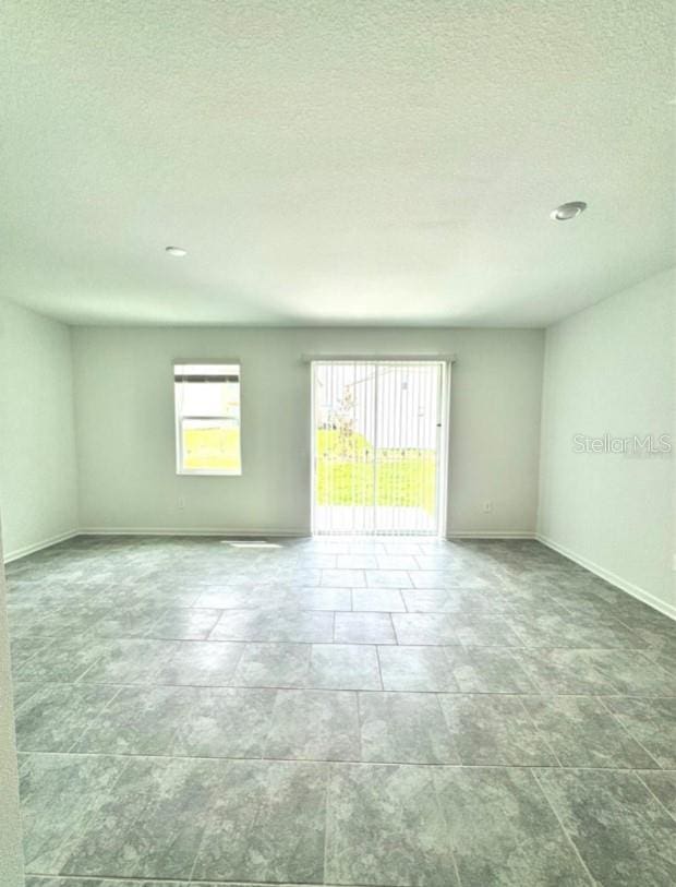 empty room with a textured ceiling