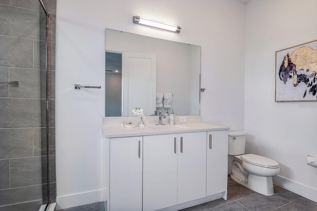 bathroom featuring tile patterned flooring, vanity, toilet, and a tile shower