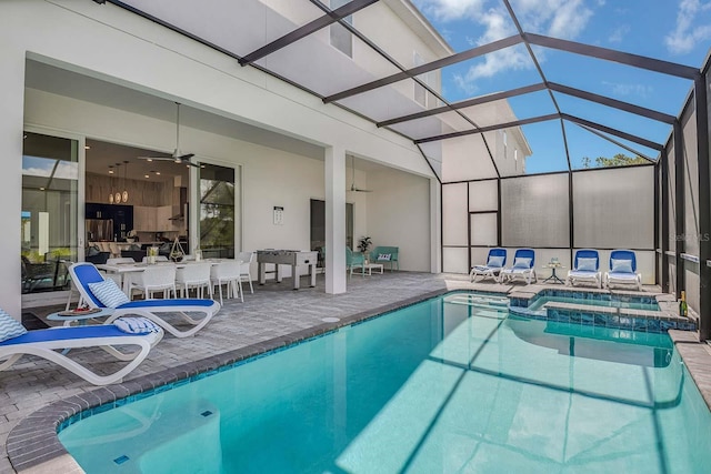 view of pool featuring a patio, ceiling fan, and a lanai