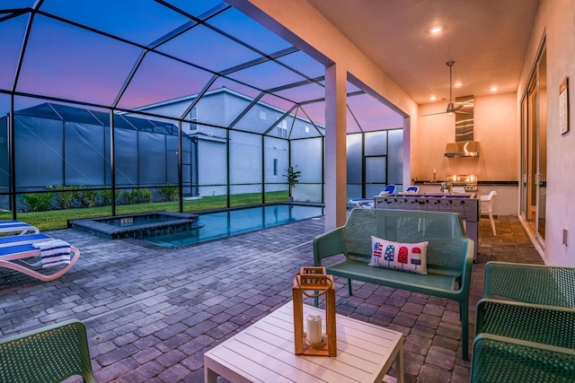 patio terrace at dusk featuring an in ground hot tub and glass enclosure