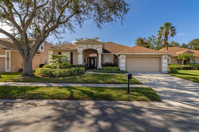 view of front of house featuring a garage and a front lawn