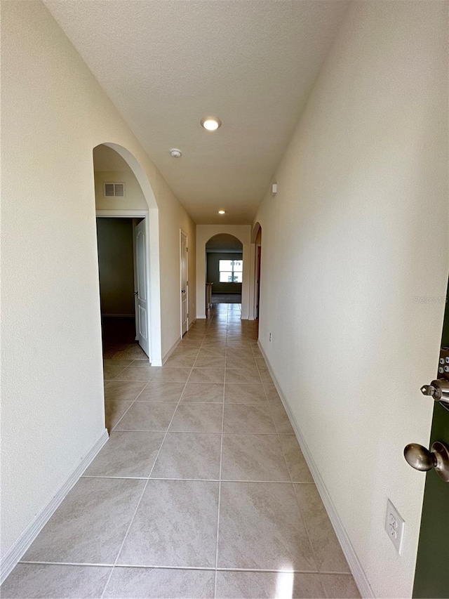 corridor featuring light tile patterned floors