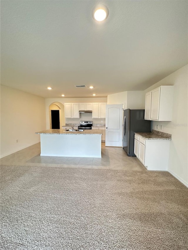 kitchen featuring white cabinets, light carpet, a kitchen island with sink, and appliances with stainless steel finishes