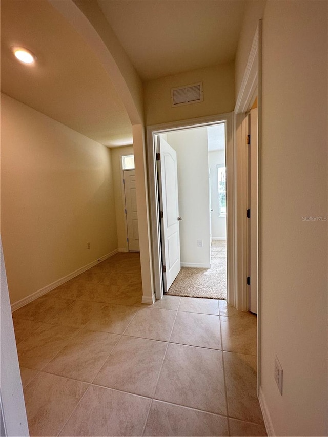 hall featuring light tile patterned floors