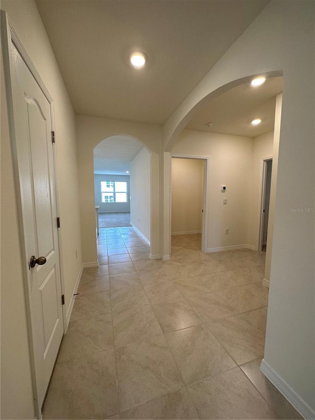 hallway with light tile patterned floors