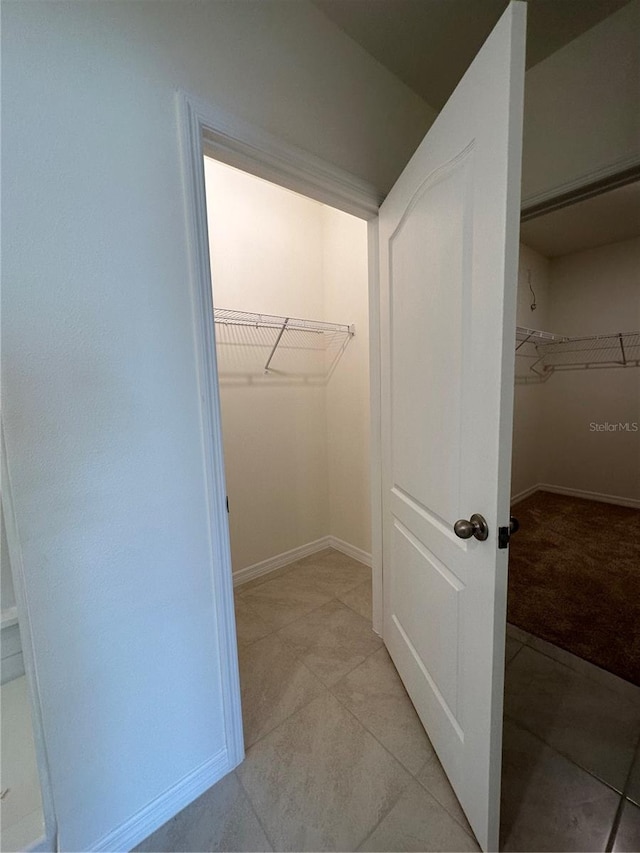 walk in closet featuring light tile patterned floors