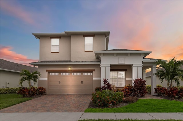 5075 Twin Lakes Blvd, Saint Cloud, FL 34772 - prairie-style home with decorative driveway, stucco siding, an attached garage, and a front yard