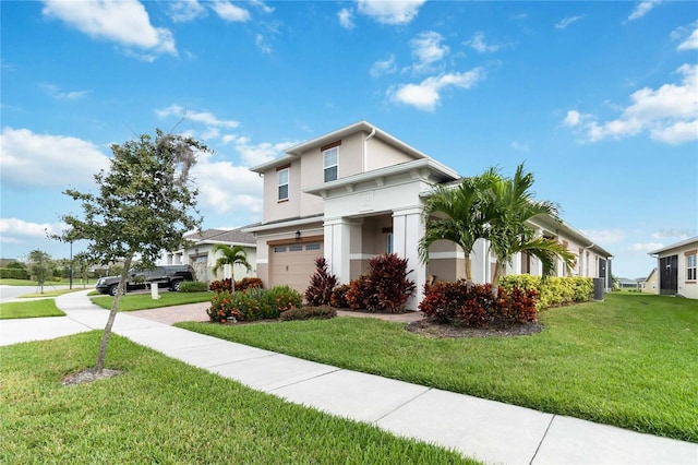 5075 Twin Lakes Blvd, Saint Cloud, FL 34772 - view of front of home with stucco siding, a garage, a front yard, and driveway