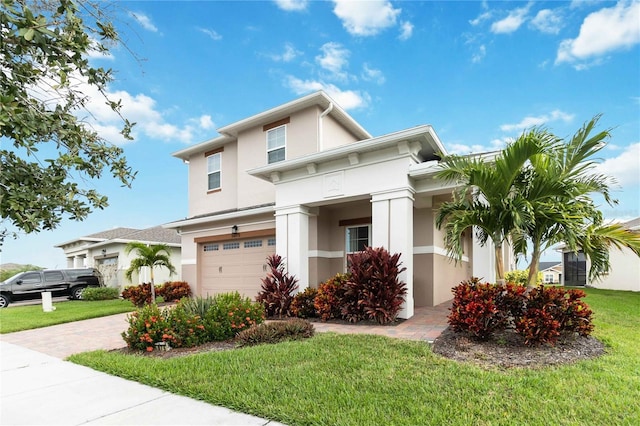 5075 Twin Lakes Blvd, Saint Cloud, FL 34772 - view of front of home featuring stucco siding, a garage, a front yard, and decorative driveway