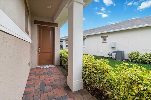 5075 Twin Lakes Blvd, Saint Cloud, FL 34772 - view of exterior entry with stucco siding and central AC