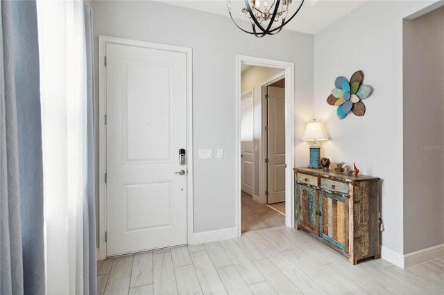 entrance foyer with light wood-type flooring and a chandelier