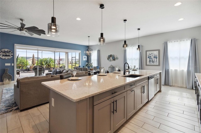 5075 Twin Lakes Blvd, Saint Cloud, FL 34772 - kitchen with a sink, dishwasher, a center island with sink, ceiling fan, and recessed lighting