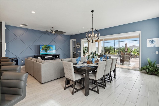 dining space featuring ceiling fan with notable chandelier and light hardwood / wood-style flooring